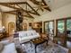 Spacious Gathering room with high ceilings, exposed beams, and hardwood floors at 2901 Leprechaun Ln, Palm Harbor, FL 34683