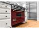 Upscale kitchen features a red Viking range and stainless steel appliances at 2901 Leprechaun Ln, Palm Harbor, FL 34683