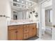 Bathroom with double sinks, granite countertop, and a separate tub and shower at 2901 Leprechaun Ln, Palm Harbor, FL 34683