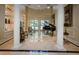 Spacious living room with high ceilings, marble floors, and grand piano at 2901 Leprechaun Ln, Palm Harbor, FL 34683