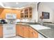 Well-equipped kitchen with light wood cabinets and dark countertops at 2901 Leprechaun Ln, Palm Harbor, FL 34683