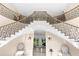 Elegant double staircase with ornate railings in a large foyer at 2901 Leprechaun Ln, Palm Harbor, FL 34683