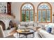 Living room with stone fireplace and large windows at 2901 Leprechaun Ln, Palm Harbor, FL 34683