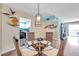 Bright dining area with glass table and wicker chairs, adjacent to kitchen at 10365 Paradise Blvd # 24, Treasure Island, FL 33706