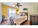 Bedroom with a queen bed, ceiling fan, and access to a balcony at 10365 Paradise Blvd # 24, Treasure Island, FL 33706