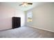 Simple bedroom with a black dresser, neutral carpet, and a window providing natural light at 105 Cascade Bend Dr, Ruskin, FL 33570