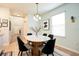 Well-lit dining area with a round table, elegant chandelier, and stylish decor at 105 Cascade Bend Dr, Ruskin, FL 33570