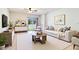 Bright living room features modern furniture, neutral tones, and a sliding door to the backyard at 105 Cascade Bend Dr, Ruskin, FL 33570