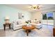 Inviting living room showcasing an L-shaped sofa, a round wooden table, and a sliding glass door at 105 Cascade Bend Dr, Ruskin, FL 33570