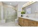 Bathroom featuring a glass shower, wooden vanity with drawers, and a large mirror with gold trim at 2121 Bayou Grande Ne Blvd, St Petersburg, FL 33703