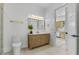 Bright bathroom with a wooden vanity with drawers, marble countertop, and a view to the kitchen at 2121 Bayou Grande Ne Blvd, St Petersburg, FL 33703
