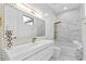Elegant bathroom with white and gold fixtures, hexagon tile accent wall, and a luxurious soaking tub at 2121 Bayou Grande Ne Blvd, St Petersburg, FL 33703