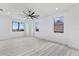 Spacious bedroom with white walls, light wood floors, recessed lighting and a contemporary ceiling fan at 2121 Bayou Grande Ne Blvd, St Petersburg, FL 33703