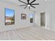 Bright bedroom with light wood floors, recessed lighting, fan, and large windows offering an abundance of natural light at 2121 Bayou Grande Ne Blvd, St Petersburg, FL 33703