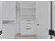 Walk-in closet featuring built-in shelving, drawers, and ample storage space at 2121 Bayou Grande Ne Blvd, St Petersburg, FL 33703