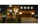 Beautiful two-story home boasting stone accents, a fenced lawn, and a paver driveway illuminated at night at 2121 Bayou Grande Ne Blvd, St Petersburg, FL 33703