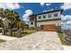Beautiful home featuring a two-car garage, landscaped yard, stone accents, and ample driveway space at 2121 Bayou Grande Ne Blvd, St Petersburg, FL 33703