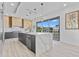 Bright, spacious kitchen with gray cabinets, waterfall island, and stainless steel appliances at 2121 Bayou Grande Ne Blvd, St Petersburg, FL 33703