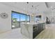 Modern kitchen featuring a large island, stainless steel appliances, and sliding glass doors with stunning water views at 2121 Bayou Grande Ne Blvd, St Petersburg, FL 33703