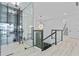 Bright landing with modern light fixture, glass railings, and wine storage at 2121 Bayou Grande Ne Blvd, St Petersburg, FL 33703