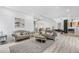 An open-concept living room with light wood floors and access to other parts of the house at 2121 Bayou Grande Ne Blvd, St Petersburg, FL 33703