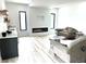 Contemporary living area with a modern fireplace, wet bar, recessed lighting, and minimalist design for comfortable and stylish living at 2121 Bayou Grande Ne Blvd, St Petersburg, FL 33703