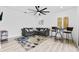 This modern living room includes a gray couch, a floral rug, and a bistro-style table with seating at 2121 Bayou Grande Ne Blvd, St Petersburg, FL 33703