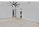 A minimalist main bedroom with light wood floors and ensuite bathroom at 2121 Bayou Grande Ne Blvd, St Petersburg, FL 33703