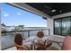 Covered patio with beautiful water views, ceiling fan, and stylish wicker furniture for outdoor dining at 2121 Bayou Grande Ne Blvd, St Petersburg, FL 33703