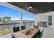 Covered patio with beautiful water views, outdoor kitchen and dining set adorned with decorative starfish at 2121 Bayou Grande Ne Blvd, St Petersburg, FL 33703