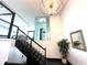 Modern staircase featuring glass panels, dark wood steps, and contemporary lighting fixture at 2121 Bayou Grande Ne Blvd, St Petersburg, FL 33703