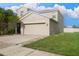 Two-story house with attached garage, driveway, and landscaping at 105 Cascade Bend Dr, Ruskin, FL 33570