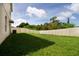 Private backyard with grassy area and vinyl fence at 105 Cascade Bend Dr, Ruskin, FL 33570