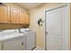 Laundry room with washer, dryer, and upper cabinets at 1086 Overland Dr, Spring Hill, FL 34608