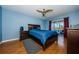 Bright bedroom with wood floors, a ceiling fan, and sliding glass doors to balcony at 2323 Feather Sound Dr # 202, Clearwater, FL 33762