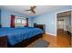 Bright bedroom with wood floors, a ceiling fan, and access to hallway at 2323 Feather Sound Dr # 202, Clearwater, FL 33762