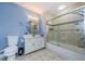 Clean bathroom with a tub, shower, and vanity with a large mirror at 2323 Feather Sound Dr # 202, Clearwater, FL 33762