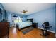 Spacious bedroom with wood floors, ceiling fan, and large window at 2323 Feather Sound Dr # 202, Clearwater, FL 33762