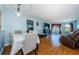 Bright living room with dining area, hardwood floors, and access to balcony at 2323 Feather Sound Dr # 202, Clearwater, FL 33762