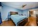Spacious bedroom with wood floors, ceiling fan, and ensuite bathroom at 2323 Feather Sound Dr # 202, Clearwater, FL 33762