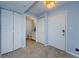 Light blue entryway with tile floors, white doors, and a small bathroom at 2323 Feather Sound Dr # 202, Clearwater, FL 33762