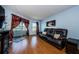 Living room with a brown reclining sofa and access to balcony at 2323 Feather Sound Dr # 202, Clearwater, FL 33762