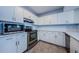 Modern kitchen with white cabinets, stainless steel appliances, and tile floors at 2323 Feather Sound Dr # 202, Clearwater, FL 33762