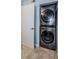 Compact laundry room with stacked washer and dryer at 2323 Feather Sound Dr # 202, Clearwater, FL 33762