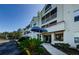 Condo building exterior with walkway and landscaping at 2323 Feather Sound Dr # 202, Clearwater, FL 33762