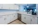 Modern kitchen with white cabinets, stainless steel appliances, and quartz countertops at 2323 Feather Sound Dr # 202, Clearwater, FL 33762