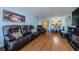 Living room with brown leather couches and hardwood floors at 2323 Feather Sound Dr # 202, Clearwater, FL 33762
