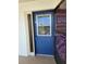 Blue front door with screen door and sidelight at 6100 12Th S St # 310, St Petersburg, FL 33705