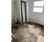 Small bedroom with closet and damaged floor at 2317 8Th E Ave, Bradenton, FL 34208