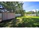 Large backyard featuring a storage shed, spacious grassy area, and full fence perimeter at 824 62Nd Ne Ave, St Petersburg, FL 33702